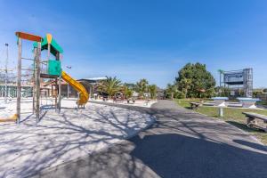 a playground with a slide in a park at Mobil-home Badji in Gastes