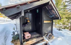a black out house with snow on the ground at Amazing Home In Eggedal With Wifi in Eggedal +10 photos