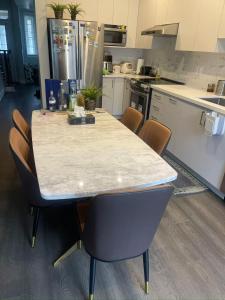 a kitchen with a table and chairs in it at Tide Manor in Markham