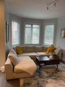 a living room with a couch and a coffee table at Tide Manor in Markham +2 photos