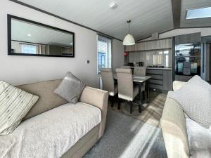 a living room with a couch and a dining room at Marina Escape One in Peterhead