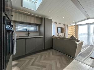 a kitchen with a sink and a couch in a room at Marina Escape One in Peterhead