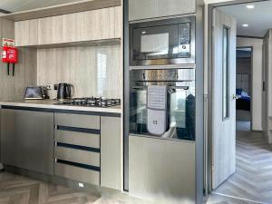 a kitchen with a stove and a counter top at Marina Escape One in Peterhead +9 photos