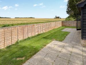 a brick fence with a field in the background at Rose Chalet in Framlingham +6 photos