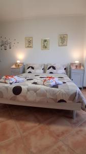 a large bed in a room with two night stands at NUOVO Alloggio Giardino di Rosy tra Roma EUR e il Mare di Ostia in Vitinia