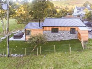 an aerial view of a wooden house with a stone wall at Llety'r Saer in Hirnant