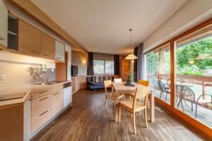 a kitchen and dining room with a table and chairs at Gasthof Residence Brugghof & Erlhof in Campo Tures