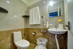 a bathroom with a toilet and a sink at RedKEY Inn Transit Hotel Bangalore Airport in Bangalore +30 photos