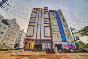 a tall building with motorcycles parked in front of it at RedKEY Inn Transit Hotel Bangalore Airport in Bangalore