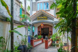 a building with plants in front of it at Bou Phanith Villa in Siem Reap