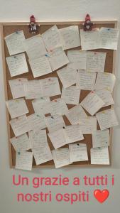 a bulletin board with sticky notes on a wall at Arduino41 in San Martino Canavese +60 photos