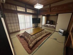 a room with a bed in the middle of a room at 民泊ごとう in Kitakami
