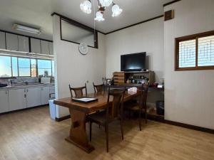 a kitchen and dining room with a table and chairs at 民泊ごとう in Kitakami