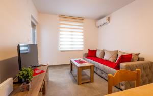 a living room with a couch and a table at Silver Sunset 26 in Veliko Gradište