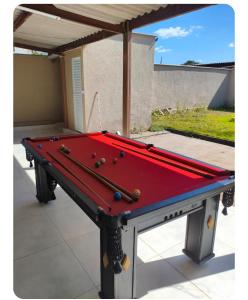 a red pool table sitting on a patio at Casa gonçalves in Trindade