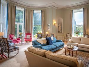 a living room with a blue couch and chairs at Dalnaglar Castle - Uk7072 in Cray