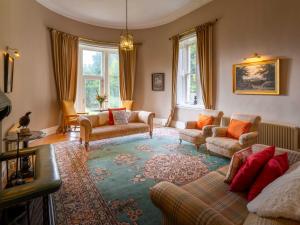 a living room with a couch and chairs and windows at Dalnaglar Castle - Uk7072 in Cray