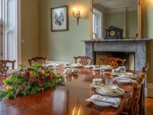 a dining room with a long table and a fireplace at Dalnaglar Castle - Uk7072 in Cray +27 photos