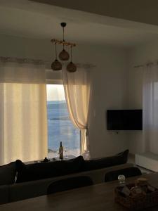 a living room with a couch and a window at Eagle's Nest Kythnos in Flampouria +29 photos