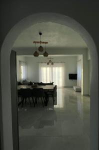 a living room with a table and a dining room at Eagle's Nest Kythnos in Flampouria
