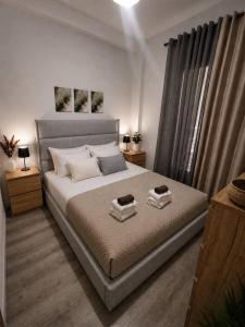 a bedroom with a bed with two towels on it at Helena's house in Ermoupoli