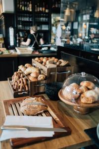 a table with various types of bread and pastries at Klostermaier Hotel & Restaurant in Icking