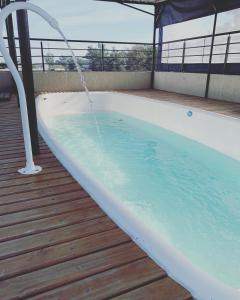 a bath tub with a water fountain on a deck at APART SUR II in Termas de Río Hondo