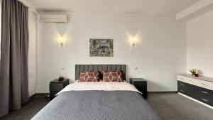 a bedroom with a large bed and two night stands at Calm Central Apartment in Kharkiv