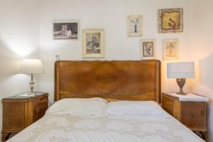 a bedroom with a large wooden bed with two lamps at Villa Corallo in Villa Castelli +33 photos