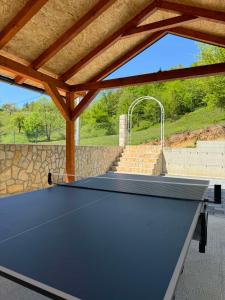 a ping pong table in a pavilion with at Vila Mirra in Teslić
