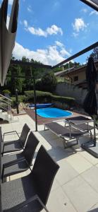 a patio with lounge chairs and a swimming pool at Dom na Červenej Veži in Banka