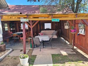 a wooden pergola with a table and chairs on a patio at Przystanek Kraszczady in Krasnystaw