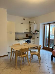 a kitchen with a wooden table and chairs in a room at Appartamento Nicoletta in Portolo