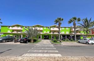 a large green building with cars parked in a parking lot at InkHouse C02 in Santa Maria