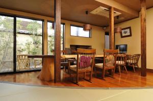 a dining room with a table and chairs at Kotonoyado Musashino in Nara
