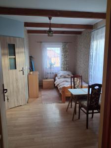 a bedroom with a bed and a table and a table and chairs at Przystanek Kraszczady in Krasnystaw