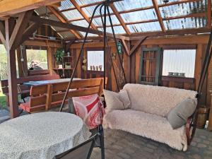 a living room with a couch and a table at Przystanek Kraszczady in Krasnystaw