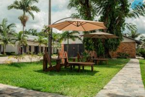 a picnic table and two chairs under an umbrella at Chandamali Bed & Breakfast in Kitwe