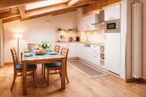 a kitchen and dining room with a table and chairs at ALPENNEST - Balcony & Sauna Access in Seefeld in Tirol