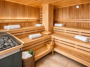 a sauna with three benches in a wooden room at ALPENNEST - Balcony & Sauna Access in Seefeld in Tirol