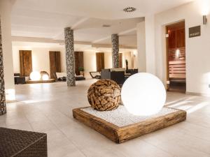 a lobby with a large orb in the middle of a room at ALPENNEST - Balcony & Sauna Access in Seefeld in Tirol +29 photos