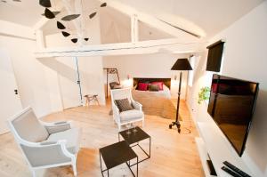 a living room with white furniture and a bed at Loft Le Saint Louis by La Chambre à Coté in Metz