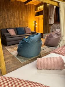 a living room with a couch and a blue bean bag at Chata Biela Stopa in Tatranská Lomnica