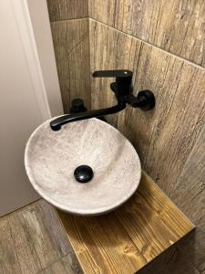 a bathroom sink sitting on a wooden floor at Chata Biela Stopa in Tatranská Lomnica +39 photos