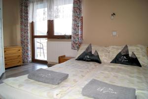a bedroom with a bed with two pillows on it at U Jasia - Agroturystyka in Bańska Niżna