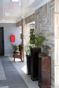 a lobby with potted plants and a red box at Oria Guest House in Cape Town