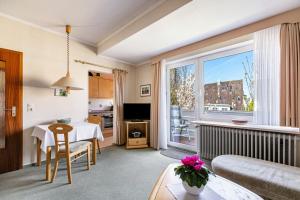 a living room with a couch and a table at Haus Passat in Büsum