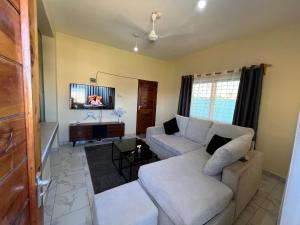 a living room with a couch and a tv at The Wink apartments in Malindi