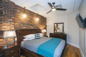 a bedroom with a bed and a brick wall at The Library-Downtown Nashville Luxury Penthouse Printers Alley Steps to Broadway in Nashville