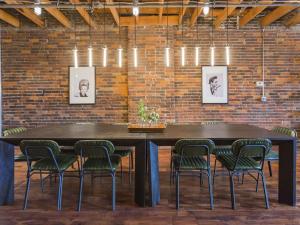 a table and chairs in a room with a brick wall at The Library-Downtown Nashville Luxury Penthouse Printers Alley Steps to Broadway in Nashville